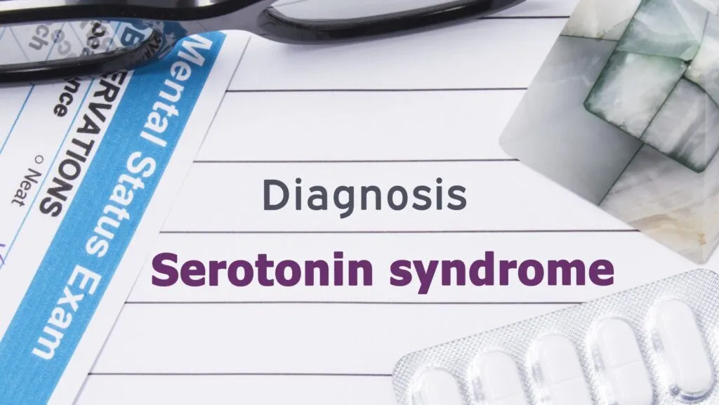 A pair of glasses and packet of tablets on top of a paper stating a diagnosis of serotonin syndrome representing NMS vs serotonin syndrome.