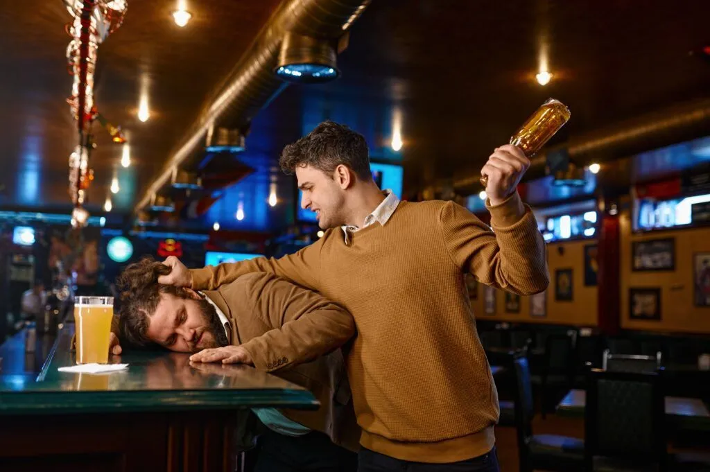 A man holding a beer bottle about to smash it into another man is an acting like an emotional drunk.