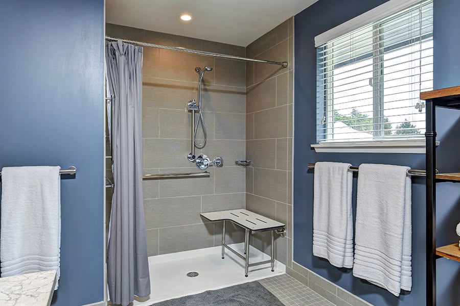 Modern bathroom with blue walls and large shower
