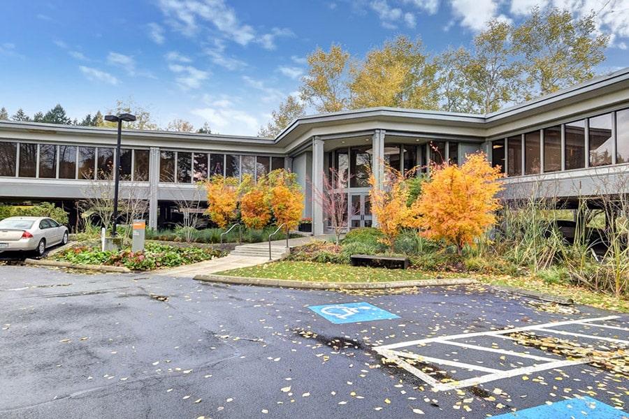 Modern rehab facility in bellevue, Washington. With fall colored trees and blue skies 