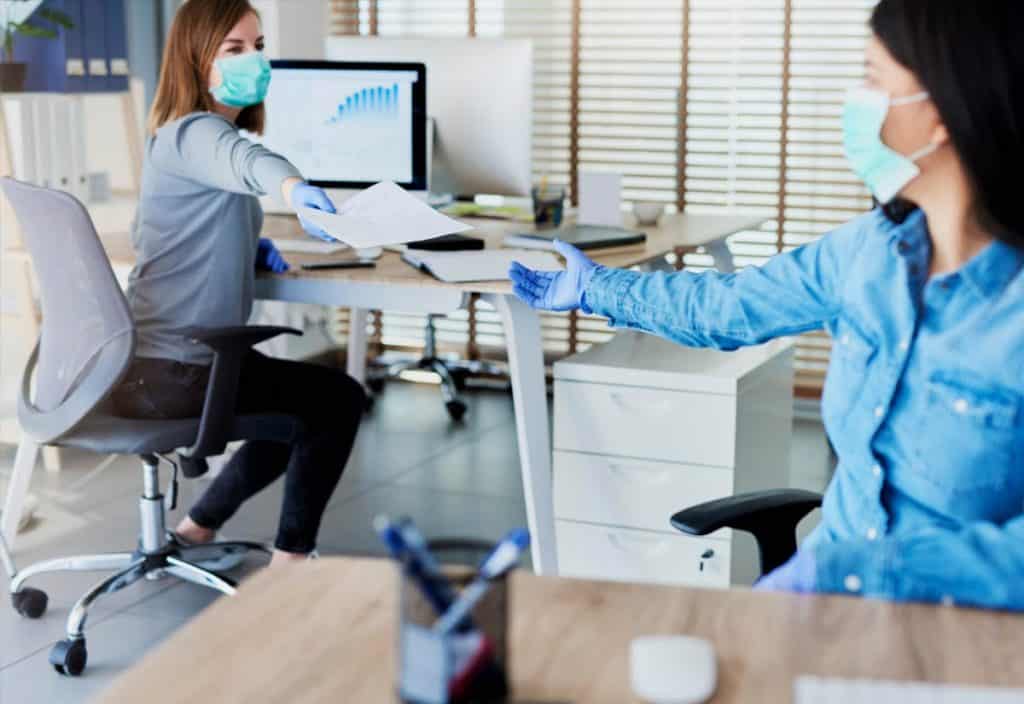 Two women in an office are working at an addiction treatment program during covid 19. 