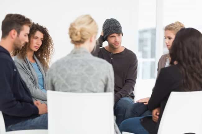 A group of patients participating in a group therapy session as part of inpatient rehab treatment.