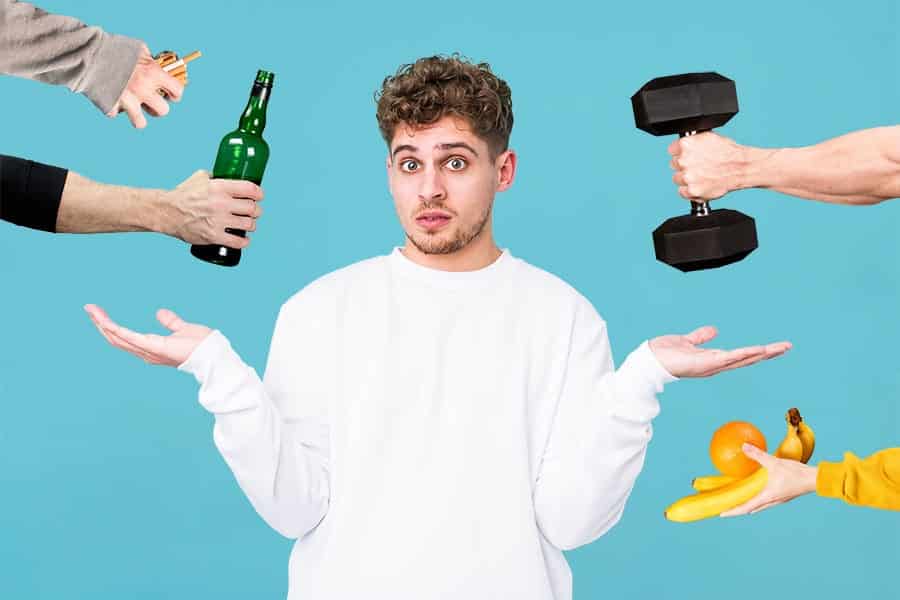 A young man surrounded by different objects represents how to choose the right drug rehab program for you. 