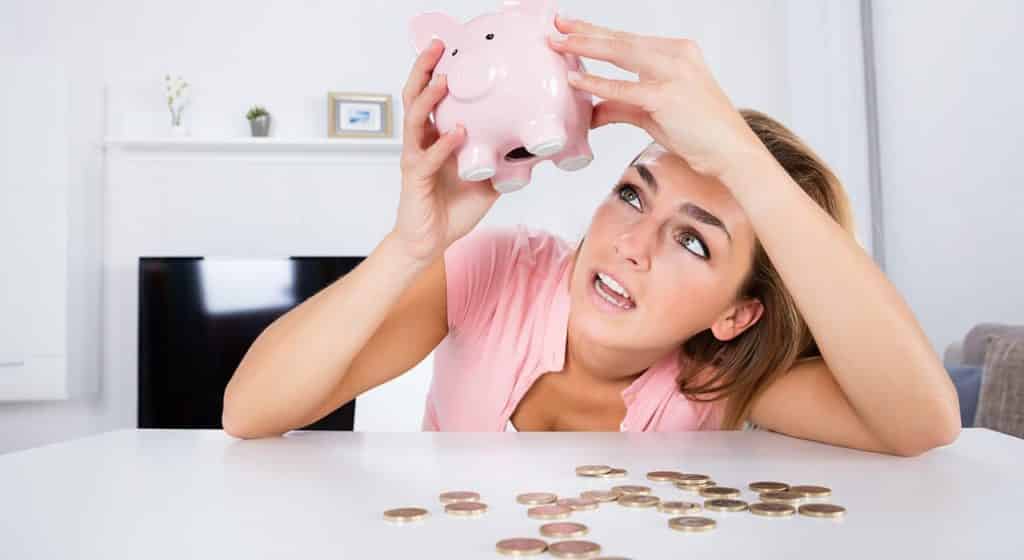 A young woman who has just relapsed is attempting to empty out her piggy bank. 