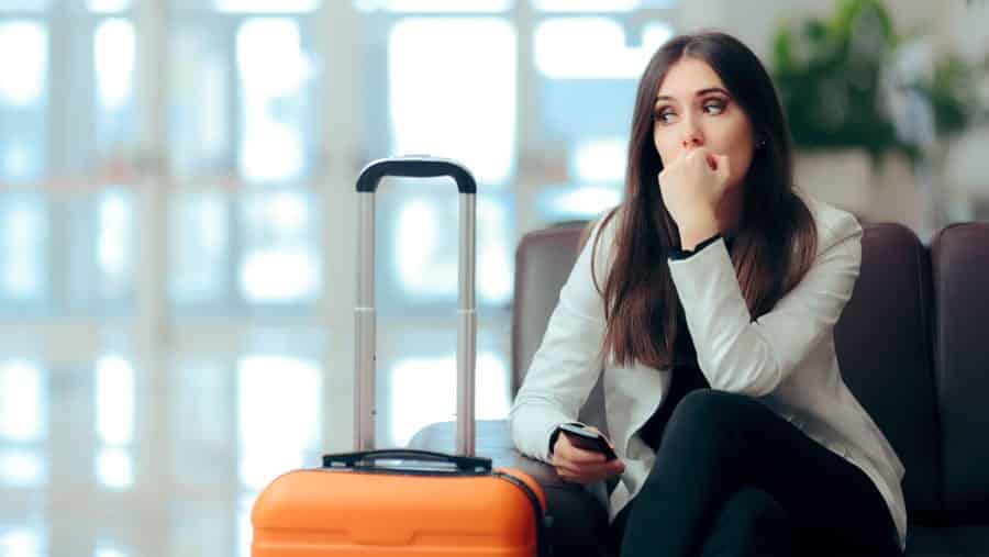 Beware: These Things Might Happen When You First Get Sober: Nervous woman with suitcase arrives at drug treatment.