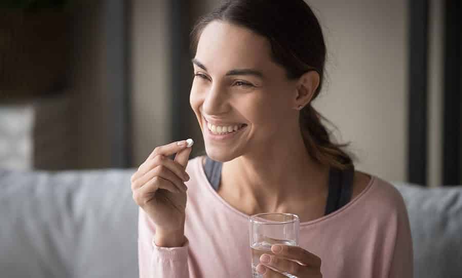 A young woman is taking medication to help with the symptoms of her co-occurring disorder as part of her treatment for substance use disorder. 