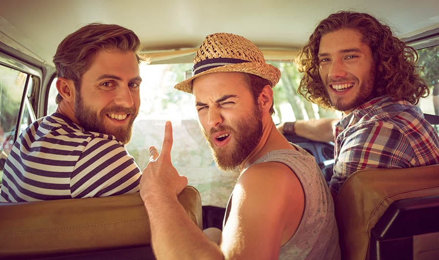 Three young men get excited to venture onto a fun road trip. 
