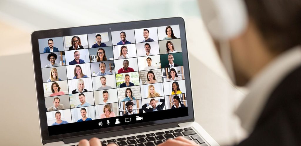 Man using laptop to video chat with a support group for addicts and alcoholics in recovery