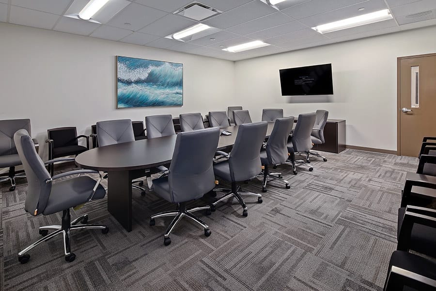 Modern conference room with large table and chairs for group therapy