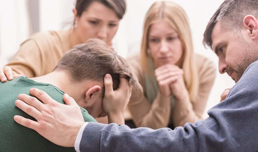 A support group consoles a man who has relapsed on drugs during the covid 19 pandemic. 