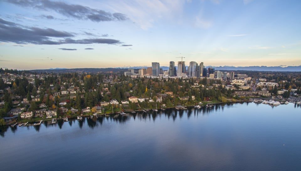 City scape of Bellevue Washington with skyline, surrounding neighborhoods and lake on a clear sunny day