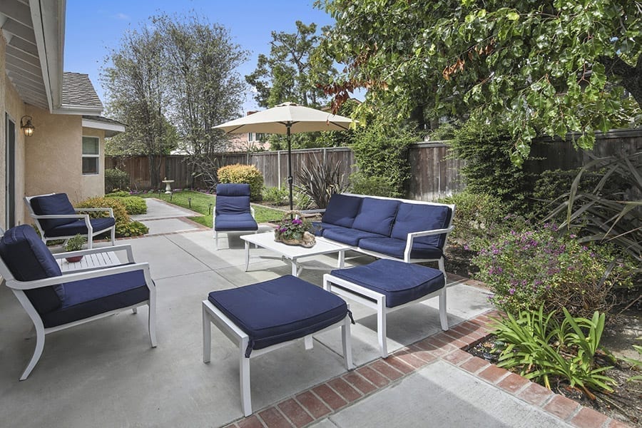 Sunny patio with blue chairs at inpatient rehab in orange county