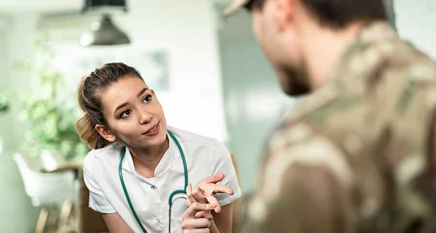 A nurse welcomes a military service member with Tricare insurance into rehab. 