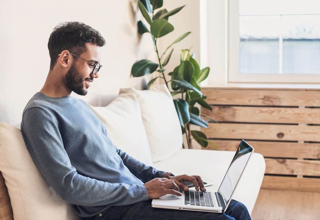 An addict in recovery on his laptop researching ways to be of service at home.