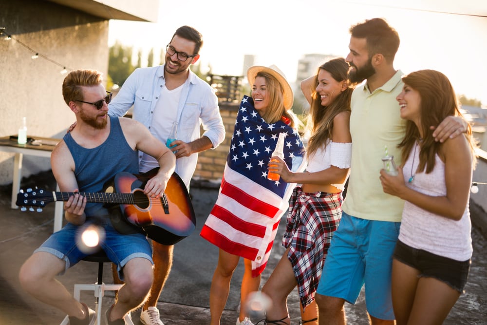 A group of young adults listening to music and discussing how to prevent excessive drinking and stay sober this Fourth of July. 