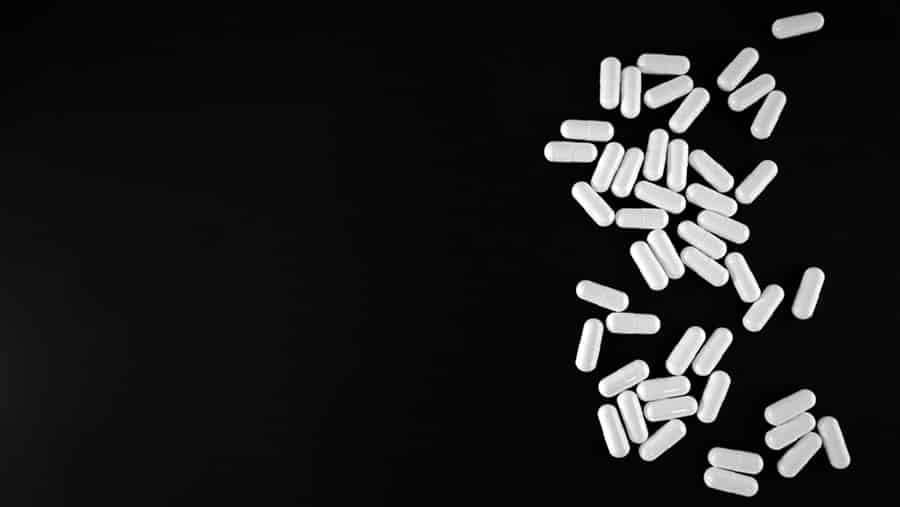 On a black background, there are white synthetic fentanyl pills laid out representing why it can be so dangerous. 
