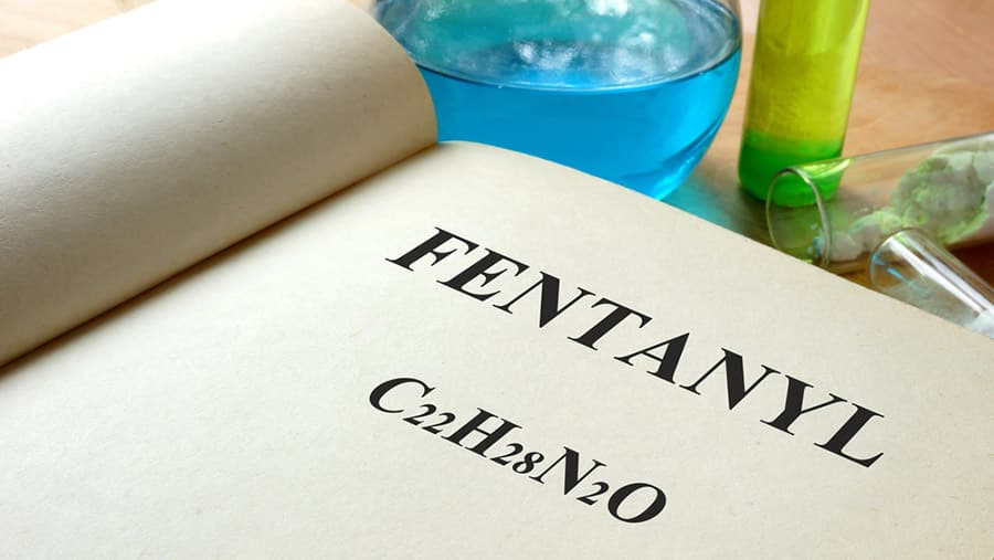 A book is opened to a page with information on fentanyl and is a metaphor for the dangers of fentanyl addiction. 