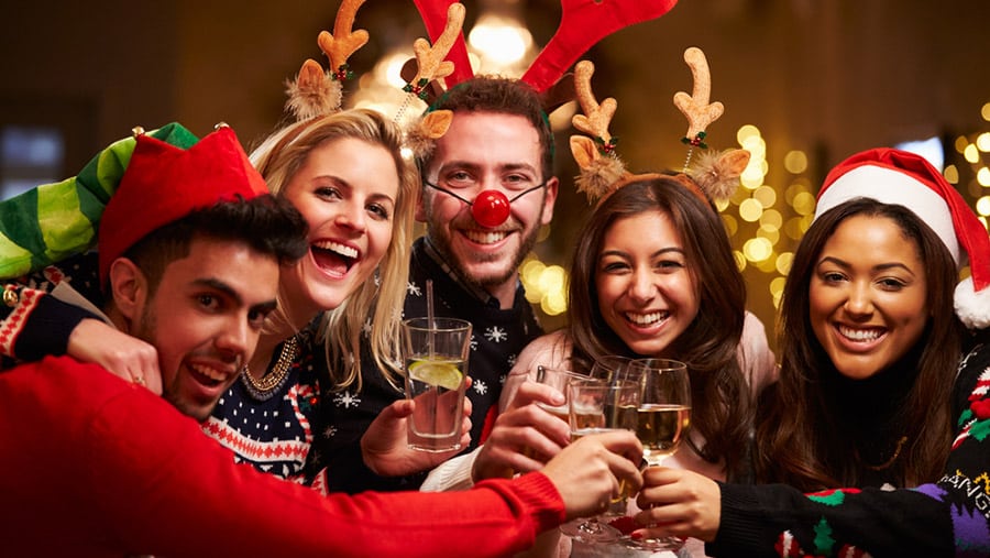 A happy group of friends toasting with alcohol can make it difficult to spot addiction during family holiday festivities.  
