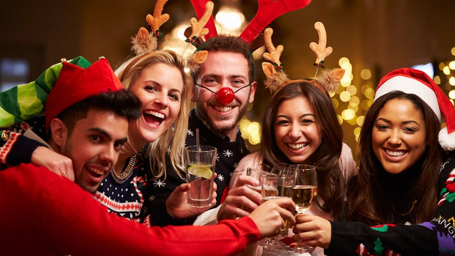 A happy group of friends toasting with alcohol can make it difficult to spot addiction during family holiday festivities.