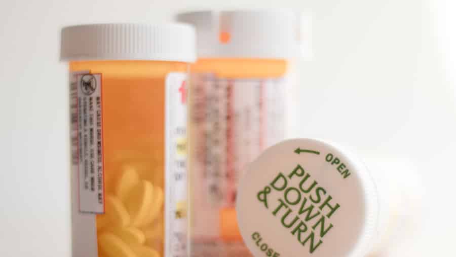 Three prescription medication bottles represent fentanyl and other prescription opioids. 