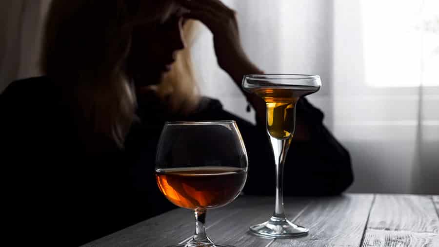 woman drinking alcohol alone