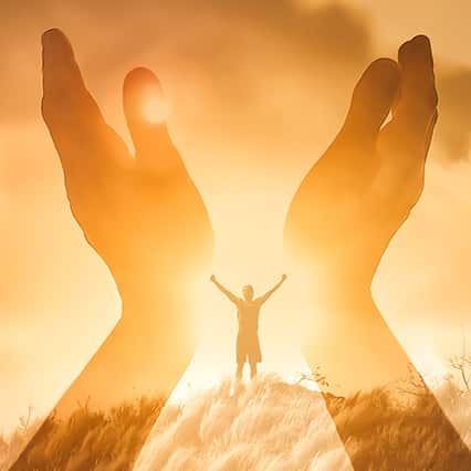 Golden filter with light profile of hands reaching up to the sky and profile of body with hands outreached in the distance