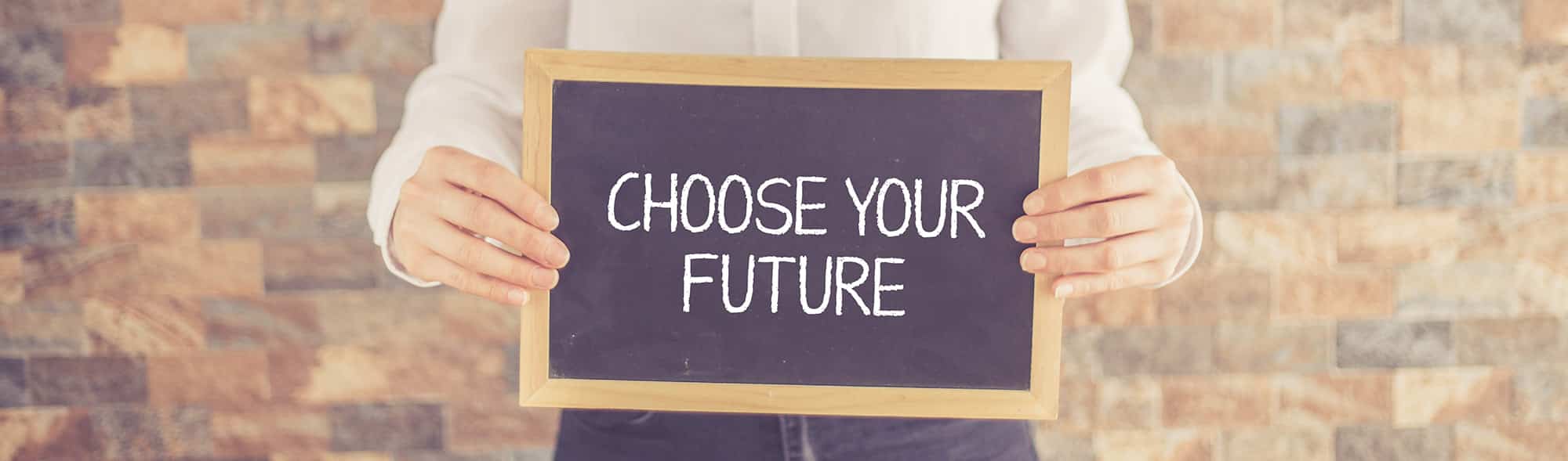 Two hands holding a chalkboard that says "Choose your future" 
