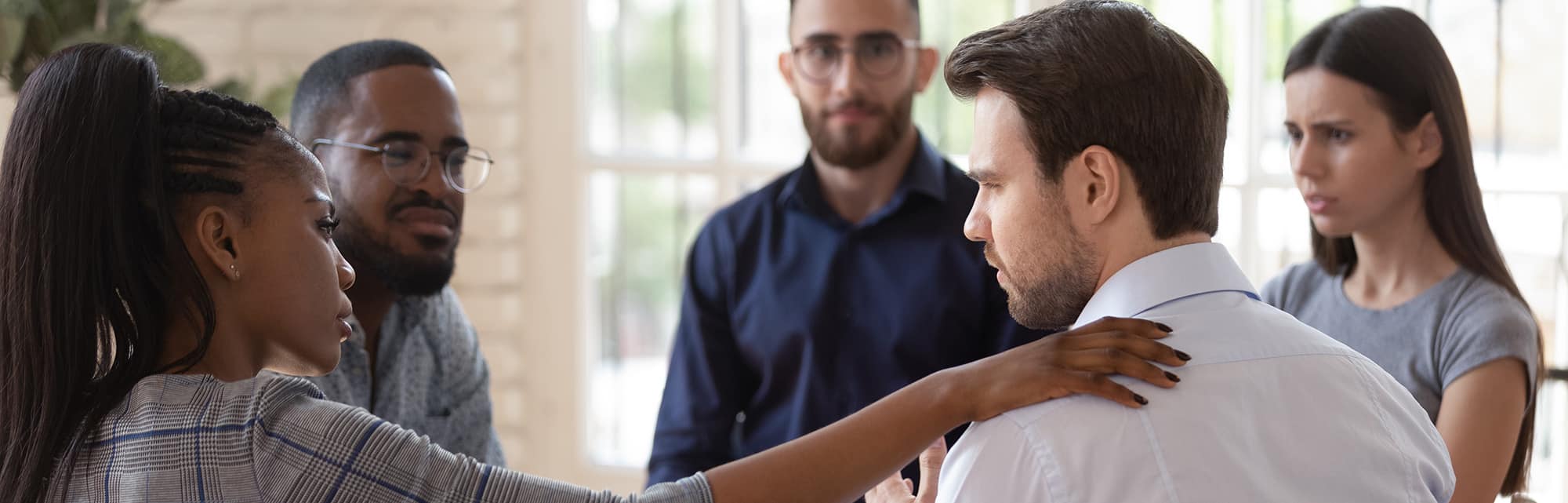 Several adults in group therapy, supporting each other in a Cincinnati Addiction Rehab