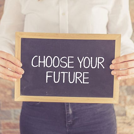 Bust of person wearing a button up shirt holding a chalkboard sign that says "choose your future"