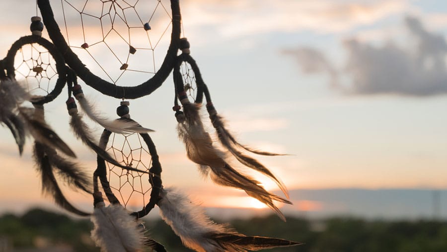 A Native American dream catcher blowing in the wind represents the state of addiction in Native American communities. 