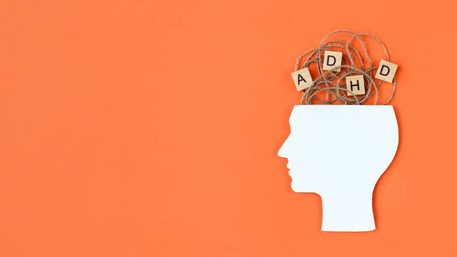On an orange background, a diagram of a person's brain represents the effects of ADHD and self medication. 