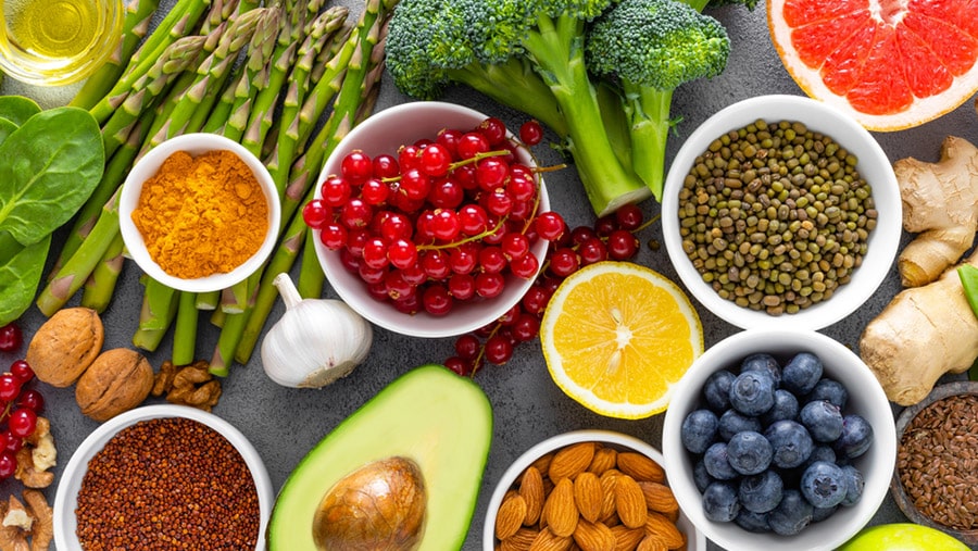 An assortment of various fruits and veggies laid out on a table representing the impact of nutrition on mental health.