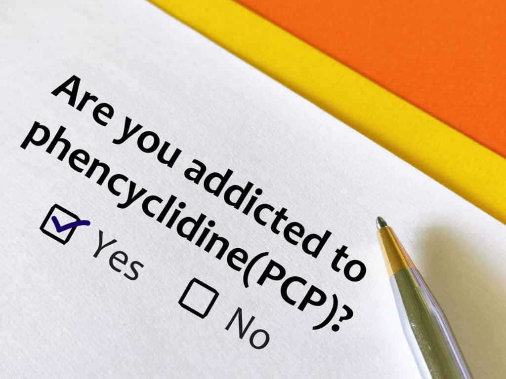A white paper and pen asking are you addicted to phencyclidine (PCP) and two boxes represent yes and no with the yes box checked.