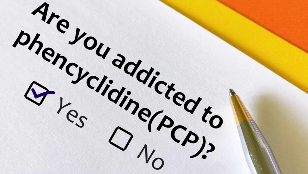 A white paper and pen asking are you addicted to phencyclidine (PCP) and two boxes represent yes and no with the yes box checked.