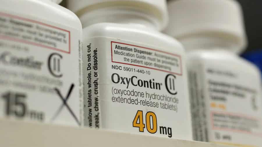 Large, close up view of oxycontin bottles on pharmacy shelf