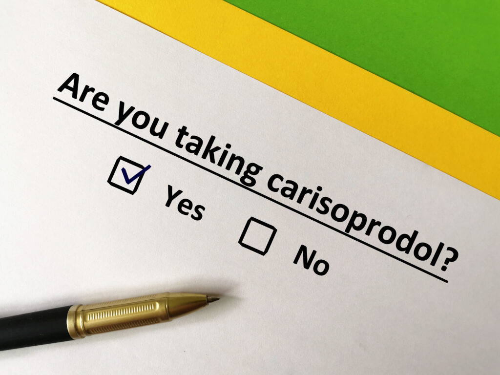 Are you taking carisoprodol is written on a piece of paper with the yes box checked. This represents the raise in muscle relaxant addiction.