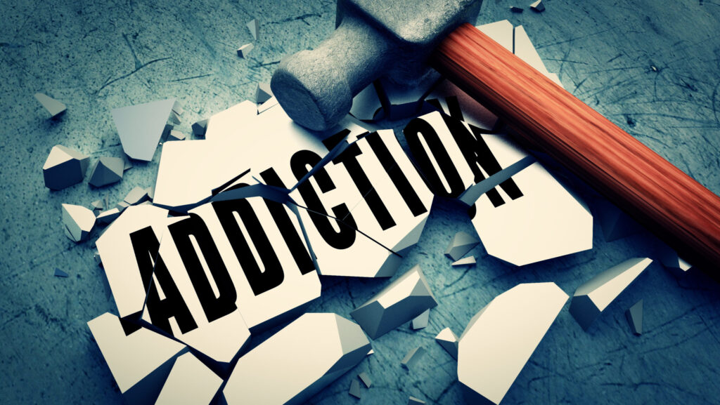 Image of the word addiction being smashed by a hammer represents how long it takes to break an addiction.
