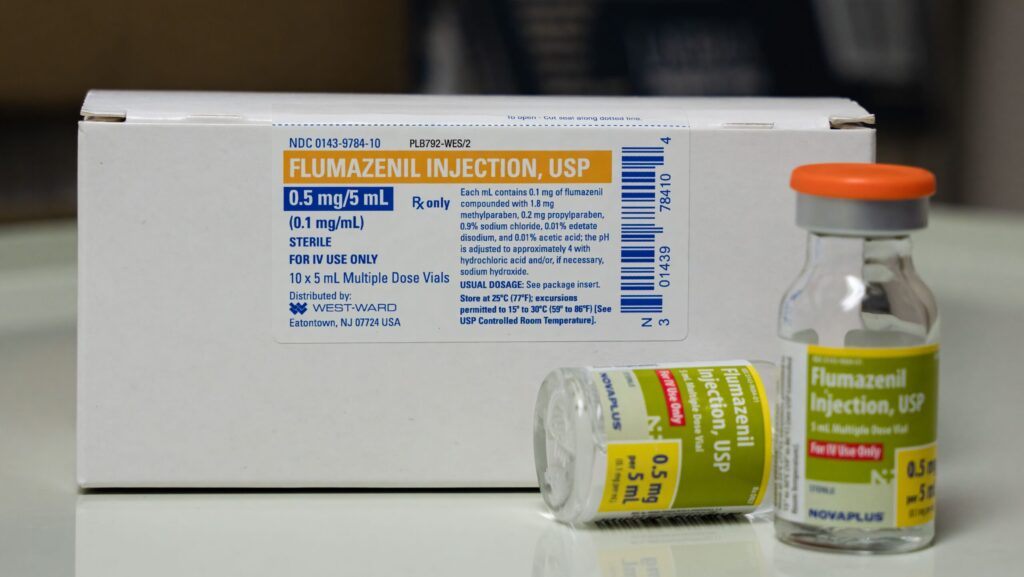 A box and glass vial of flumazenil represents how much an average flumazenil dose should be given.