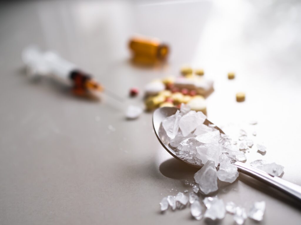 Crystal meth and meth pills laid out on a table represents how much you can take to OD on meth.