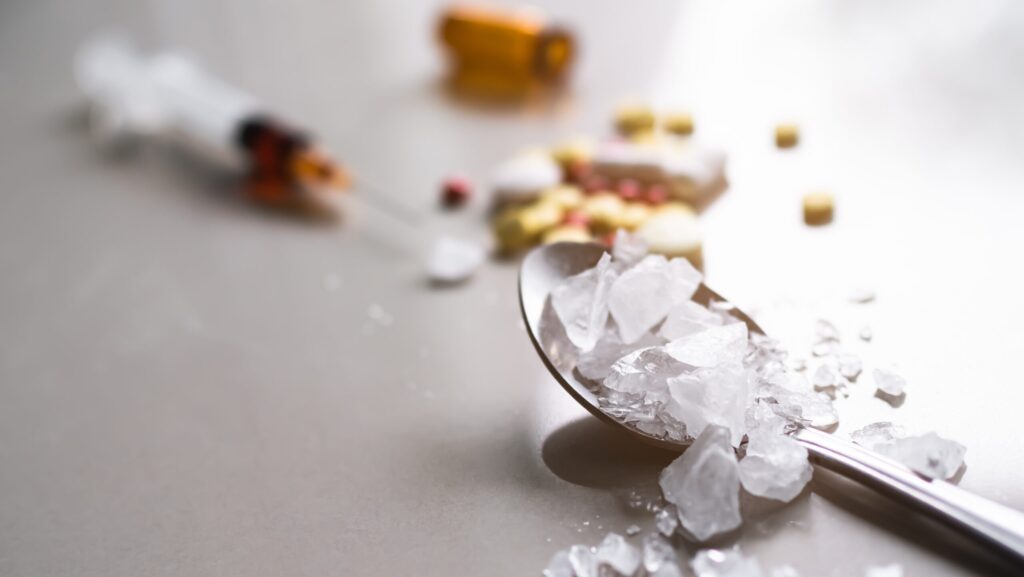Crystal meth and meth pills laid out on a table represents how much you can take to OD on meth.