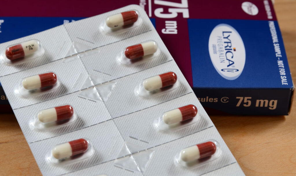 A blue and brown Lyrica medication box with red and white pill tabs.