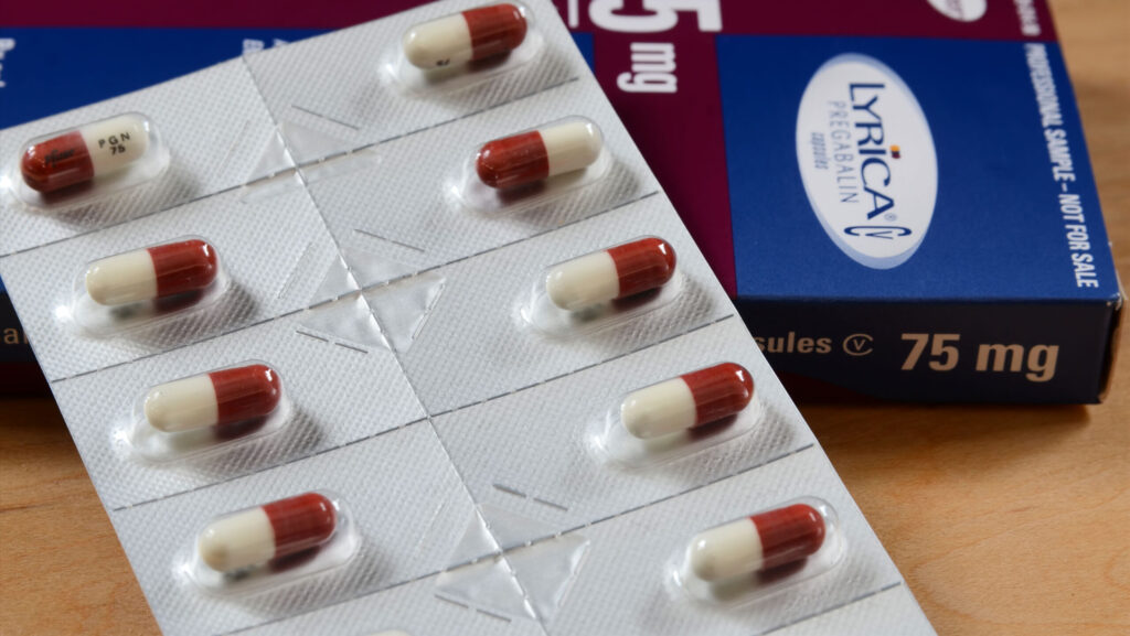 A blue and brown Lyrica medication box with red and white pill tabs.