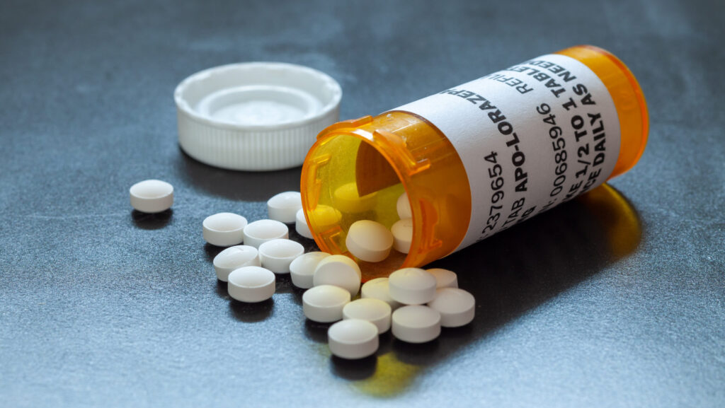 A pharmacy bottle of lorezepam spilled over because it is a pill often used to come off a benzodiazepine.