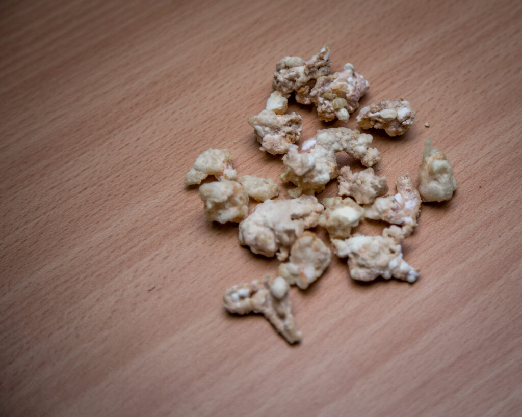 Rocks of crack cocaine laid out on a wooden table.