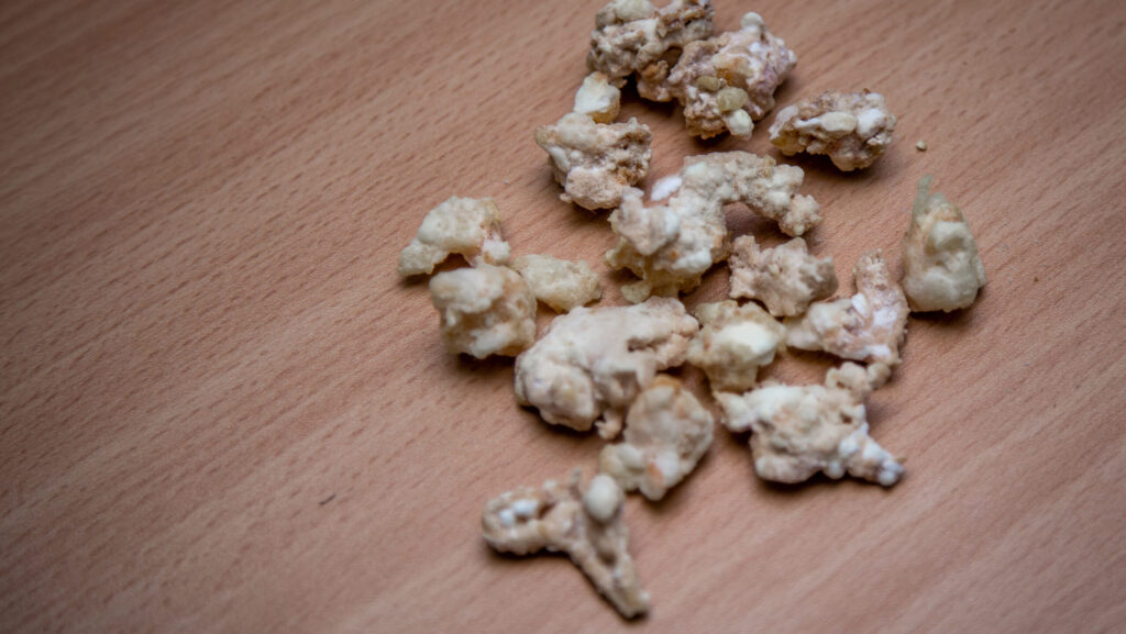 Rocks of crack cocaine laid out on a wooden table.