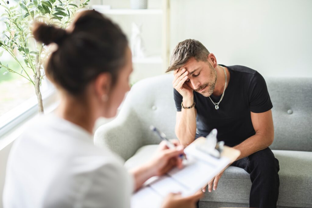 A young male addict speaking with a female profession represents one way in how to support an addict.