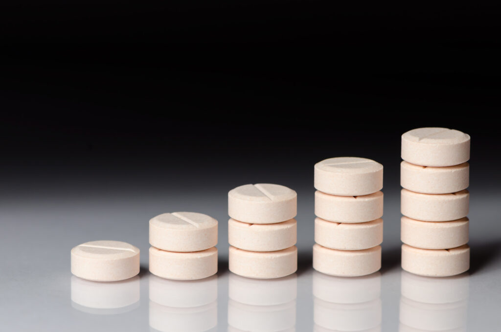 Various piles of pills representing taper medications that can help with substance use disorder treatment.