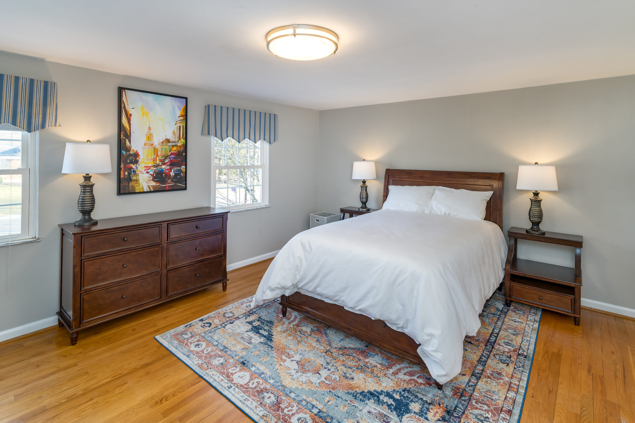 Hotel California by the Sea Ohio Detox bed, clean room with clean linens, light lit with warm grey walls and ornate blue rug