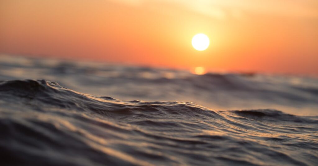 Captivating ocean waves with a vibrant sunset sky, perfect for tranquil moments.