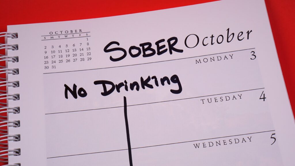 A calendar reading sober October on the page and No Drinking.